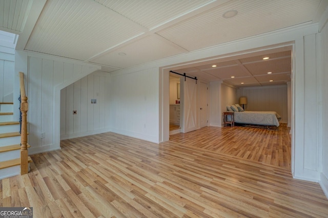 22 Waters Bridge Cir, Covington, GA 30014 - unfurnished living room featuring light wood-style flooring, stairs, recessed lighting, and baseboards