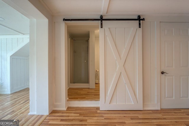 22 Waters Bridge Cir, Covington, GA 30014 - hallway featuring light wood finished floors and a barn door