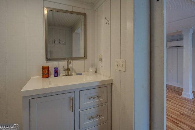 22 Waters Bridge Cir, Covington, GA 30014 - bathroom featuring a wall mounted AC, vanity, and wood finished floors