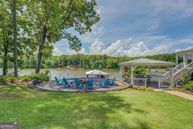 22 Waters Bridge Cir, Covington, GA 30014 - view of green lawn with a gazebo, a water view, a fire pit, and a patio area