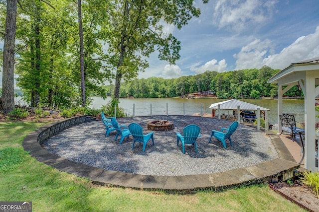 22 Waters Bridge Cir, Covington, GA 30014 - view of patio / terrace with an outdoor fire pit and a water view