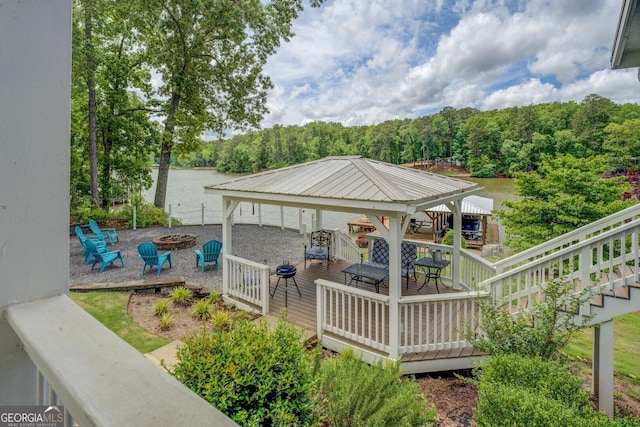 22 Waters Bridge Cir, Covington, GA 30014 - wooden deck featuring a gazebo, a fire pit, a water view, and a wooded view