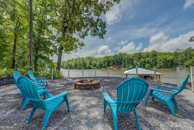 22 Waters Bridge Cir, Covington, GA 30014 - view of patio featuring a fire pit and a forest view
