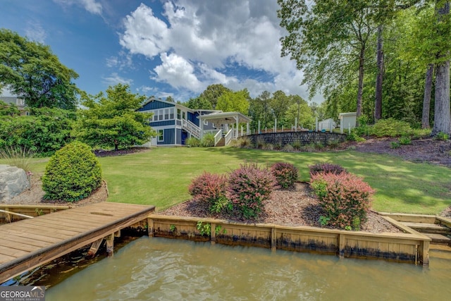 22 Waters Bridge Cir, Covington, GA 30014 - dock featuring stairs, a lawn, and a water view