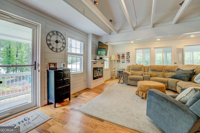 22 Waters Bridge Cir, Covington, GA 30014 - living room featuring light wood-style floors, beamed ceiling, a fireplace, wooden walls, and recessed lighting