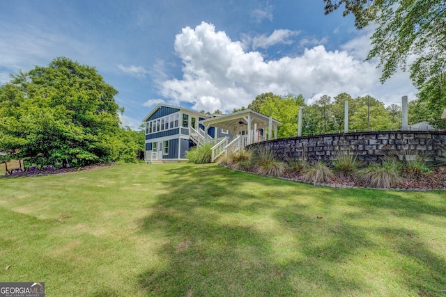22 Waters Bridge Cir, Covington, GA 30014 - view of grassy yard with stairs and a ceiling fan