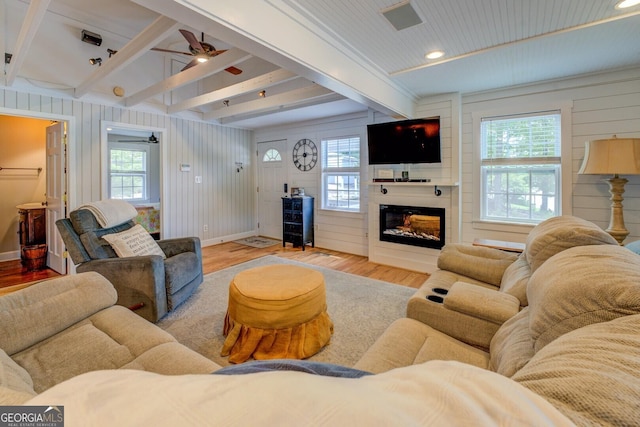 22 Waters Bridge Cir, Covington, GA 30014 - living room with wood finished floors, a ceiling fan, beam ceiling, baseboards, and a large fireplace