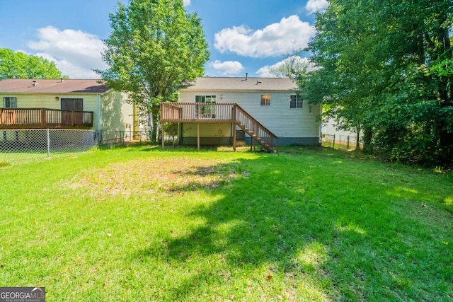 rear view of house with stairs and a wooden deck