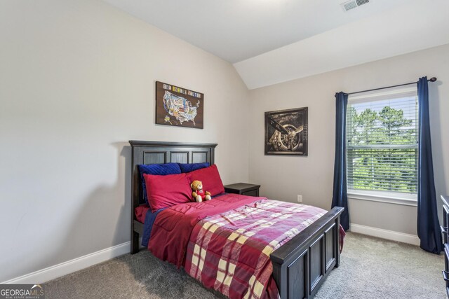 bedroom featuring light carpet, baseboards, and vaulted ceiling