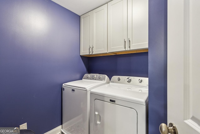 washroom with washing machine and clothes dryer and cabinet space