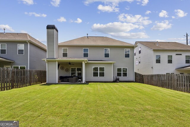 back of house with ceiling fan, an outdoor hangout area, a chimney, and a patio area