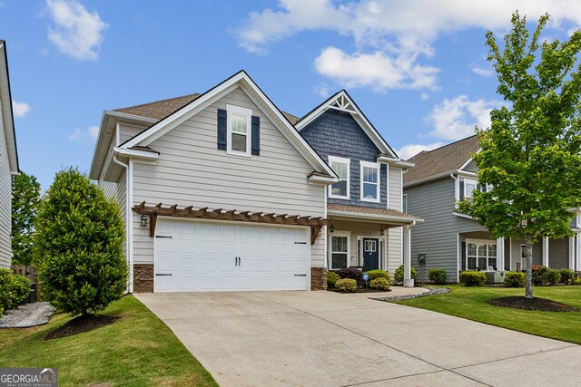 view of front of home featuring driveway, stone siding, an attached garage, and a front lawn