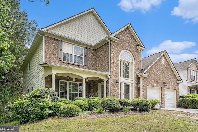 7280 Wright Dr, Atlanta, GA 30349 - traditional-style home with concrete driveway, a front yard, a garage, and brick siding