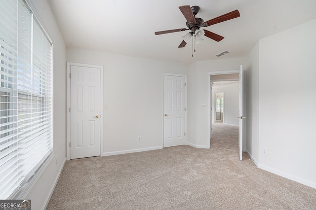 7280 Wright Dr, Atlanta, GA 30349 - unfurnished bedroom featuring light carpet and a ceiling fan