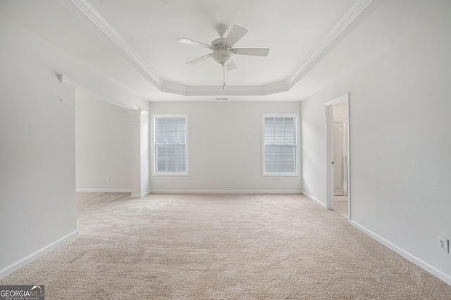 7280 Wright Dr, Atlanta, GA 30349 - spare room featuring a tray ceiling, light colored carpet, ceiling fan, and ornamental molding