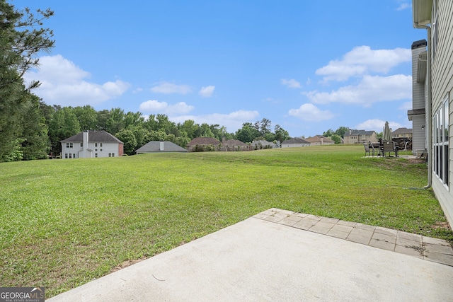 7280 Wright Dr, Atlanta, GA 30349 - view of green lawn featuring a patio and a residential view