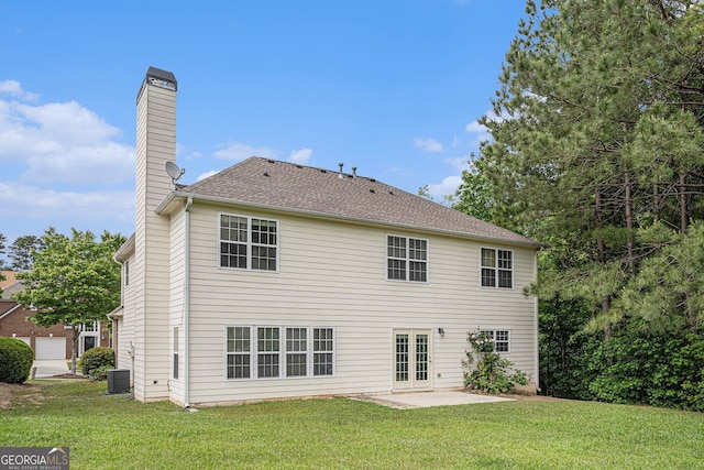 7280 Wright Dr, Atlanta, GA 30349 - rear view of house with a chimney, a lawn, a patio, and french doors