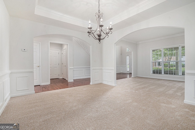 7280 Wright Dr, Atlanta, GA 30349 - unfurnished room with arched walkways, carpet, a chandelier, crown molding, and a decorative wall