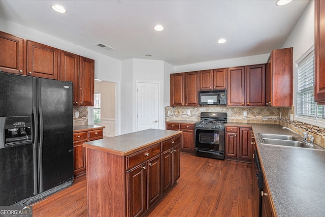 7280 Wright Dr, Atlanta, GA 30349 - kitchen with black appliances, dark wood-type flooring, backsplash, recessed lighting, and dark countertops