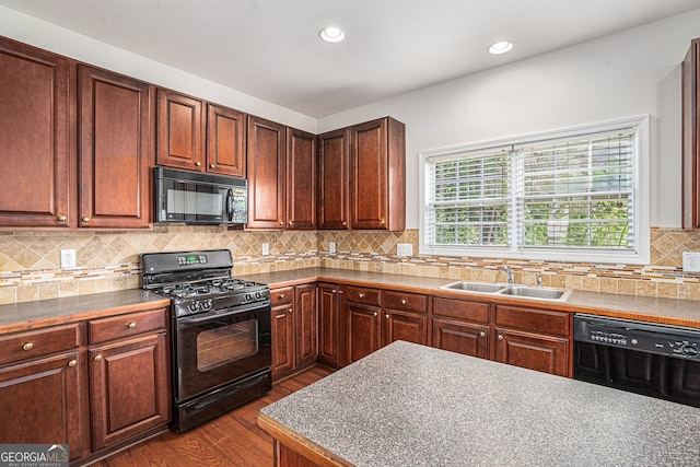 7280 Wright Dr, Atlanta, GA 30349 - kitchen with black appliances, dark wood-type flooring, backsplash, and recessed lighting