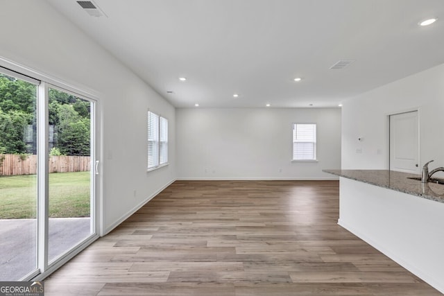 630 Evergreen Rd, Winder, GA 30680 - unfurnished living room featuring recessed lighting, light wood finished floors, baseboards, and a sink
