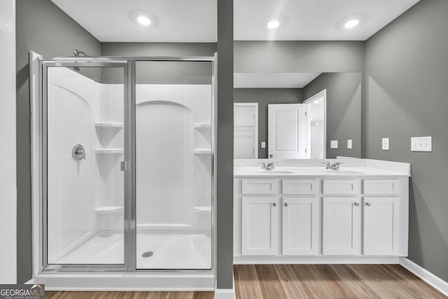 630 Evergreen Rd, Winder, GA 30680 - full bath featuring a shower stall, wood finished floors, double vanity, and baseboards