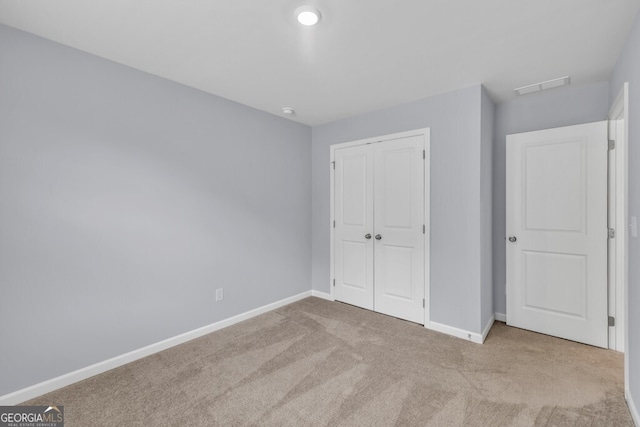630 Evergreen Rd, Winder, GA 30680 - unfurnished bedroom with carpet, baseboards, and a closet