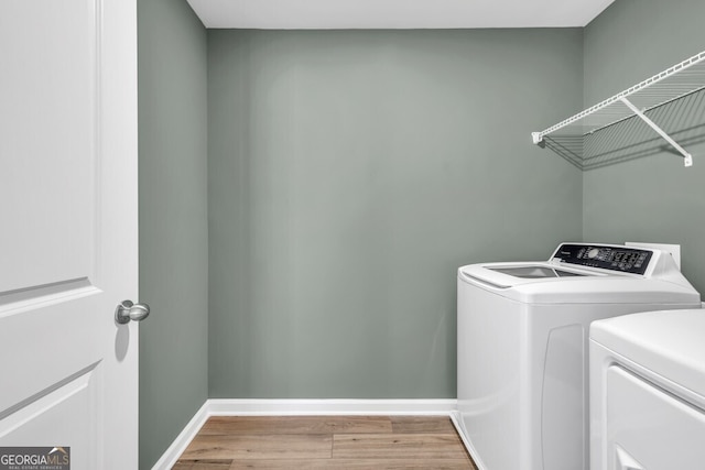 630 Evergreen Rd, Winder, GA 30680 - clothes washing area with independent washer and dryer, light wood-type flooring, and baseboards