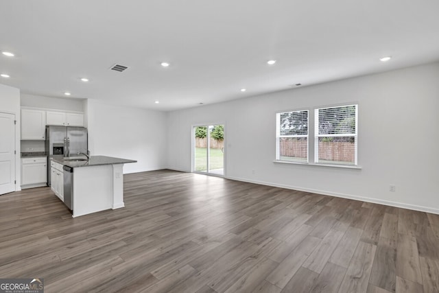 630 Evergreen Rd, Winder, GA 30680 - kitchen with open floor plan, white cabinets, recessed lighting, appliances with stainless steel finishes, and wood finished floors