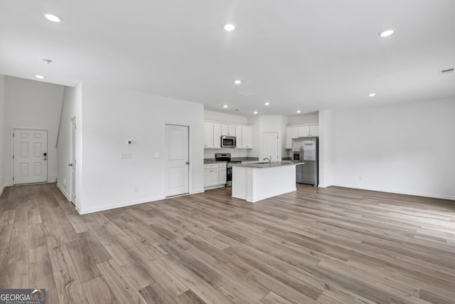 630 Evergreen Rd, Winder, GA 30680 - kitchen with appliances with stainless steel finishes, open floor plan, light wood-style floors, white cabinetry, and recessed lighting