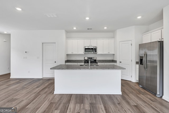 630 Evergreen Rd, Winder, GA 30680 - kitchen featuring appliances with stainless steel finishes, white cabinetry, an island with sink, dark wood-type flooring, and recessed lighting