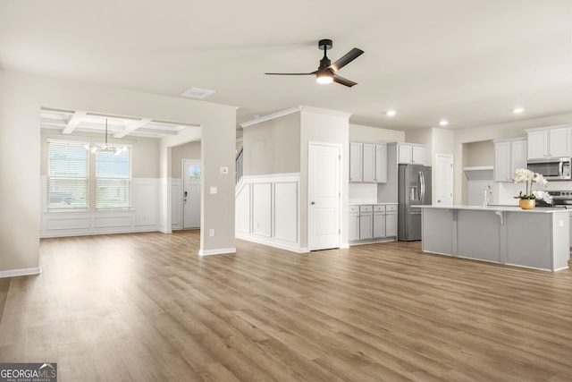 116 Cabin Way, Hampton, GA 30228 - unfurnished living room with recessed lighting, a chandelier, light wood-type flooring, coffered ceiling, and a sink