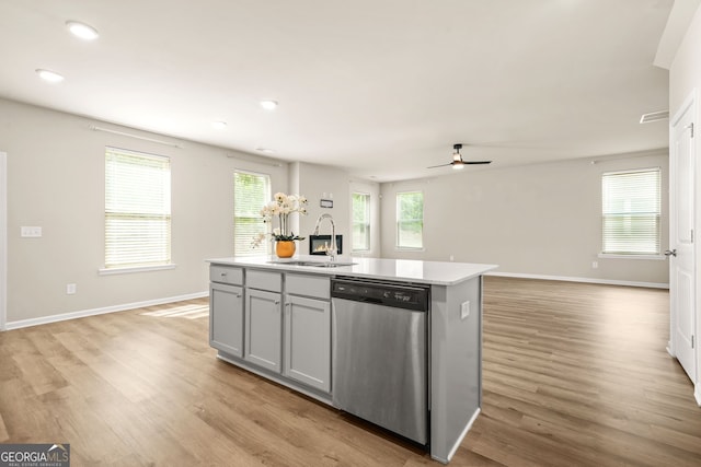 116 Cabin Way, Hampton, GA 30228 - kitchen with stainless steel dishwasher, a sink, light wood-type flooring, open floor plan, and recessed lighting