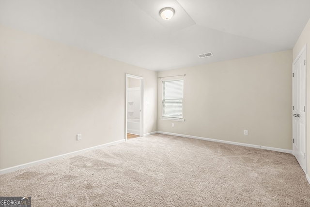 116 Cabin Way, Hampton, GA 30228 - unfurnished bedroom with carpet, baseboards, ensuite bath, and vaulted ceiling
