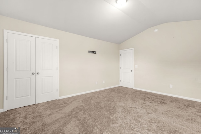 116 Cabin Way, Hampton, GA 30228 - unfurnished bedroom featuring vaulted ceiling, carpet floors, a closet, and baseboards