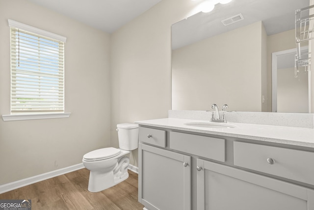 116 Cabin Way, Hampton, GA 30228 - bathroom featuring baseboards, wood finished floors, vanity, and toilet