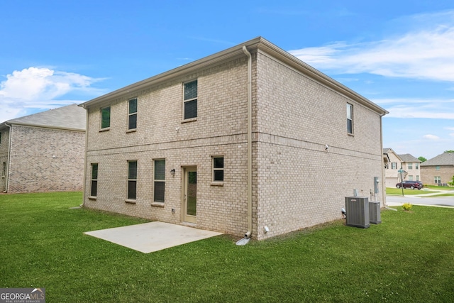 116 Cabin Way, Hampton, GA 30228 - back of house featuring a lawn, brick siding, a patio, and central AC unit