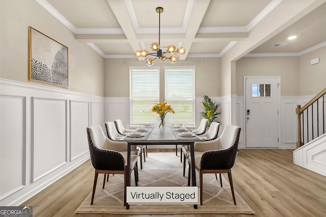 116 Cabin Way, Hampton, GA 30228 - dining space with a decorative wall, a chandelier, stairway, light wood-style flooring, and wainscoting