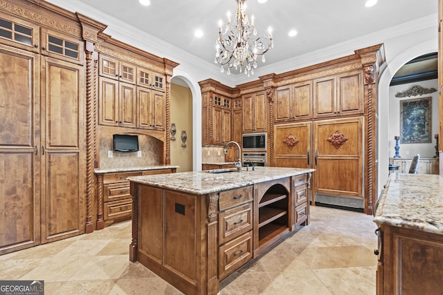 kitchen with arched walkways, appliances with stainless steel finishes, a sink, brown cabinets, and open shelves