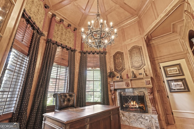 home office with a chandelier, a high end fireplace, a towering ceiling, ornamental molding, and coffered ceiling