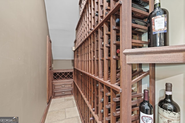 wine room with stone tile flooring and baseboards