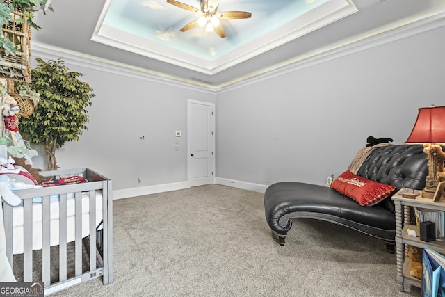 bedroom with a tray ceiling, carpet flooring, a ceiling fan, and baseboards