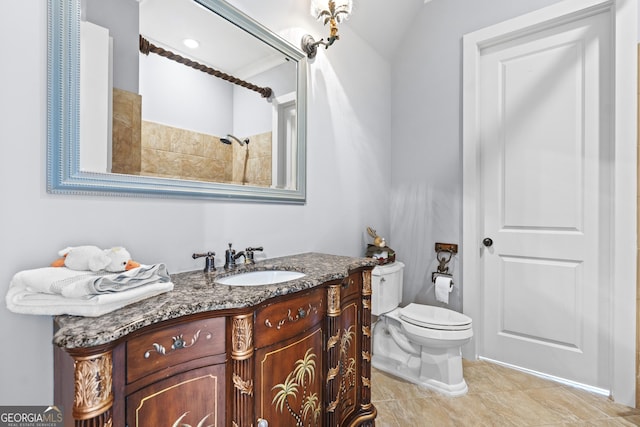 full bath featuring toilet, vanity, a shower, and tile patterned flooring