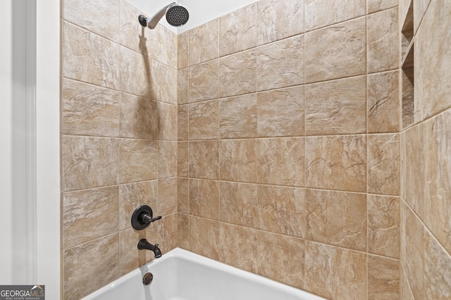 bathroom view of tub / shower combination