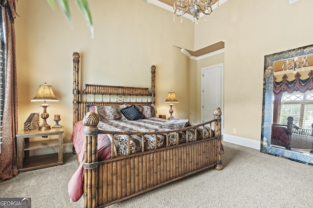 carpeted bedroom featuring a chandelier, a towering ceiling, and baseboards