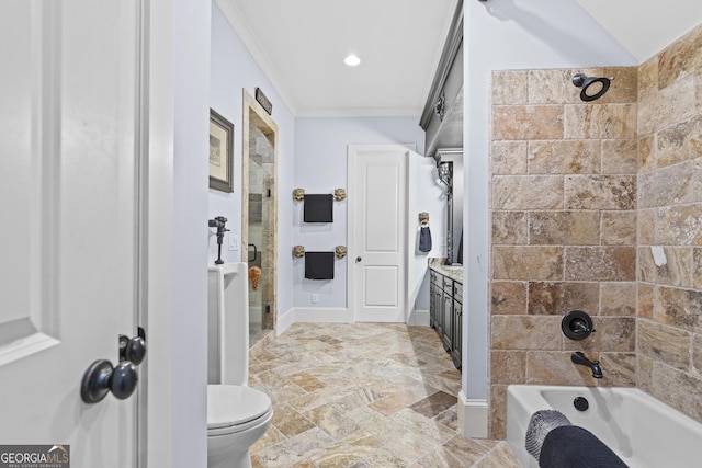 bathroom featuring vanity, stone finish floors, toilet, bathing tub / shower combination, and ornamental molding
