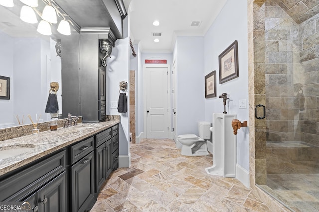 full bath with toilet, a shower stall, double vanity, stone tile flooring, and ornamental molding