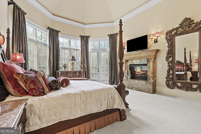 bedroom featuring carpet, multiple windows, a high end fireplace, and high vaulted ceiling