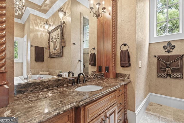 bathroom with plenty of natural light, vanity, a textured wall, and a bath