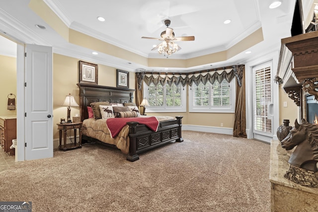 carpeted bedroom with crown molding, a tray ceiling, access to outside, recessed lighting, and baseboards